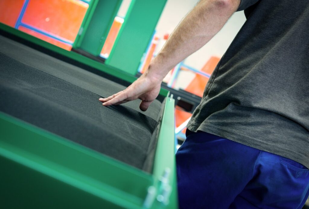 A VLP employee stood with their hand on a foam product.